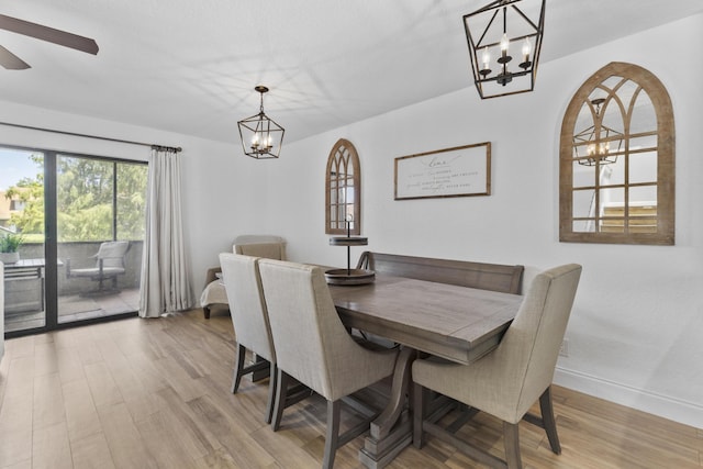 1693 Woodbridge Lakes Cir, West Palm Beach, FL 33406 - dining room with a chandelier, light wood-type flooring, baseboards, and a ceiling fan