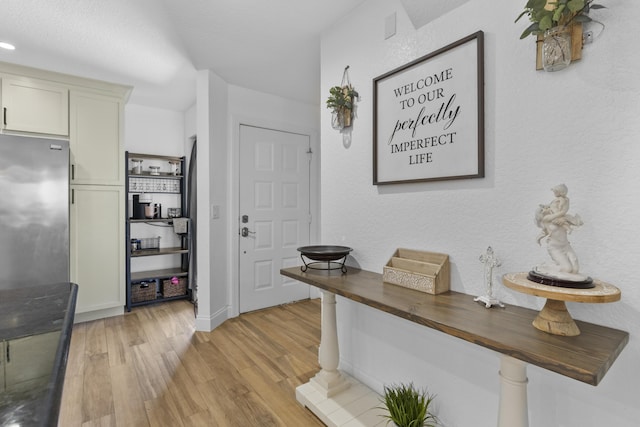 1693 Woodbridge Lakes Cir, West Palm Beach, FL 33406 - foyer featuring light wood-style flooring and baseboards