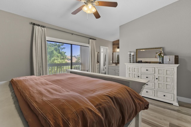 1693 Woodbridge Lakes Cir, West Palm Beach, FL 33406 - bedroom with light wood-style floors, vaulted ceiling, baseboards, connected bathroom, and ceiling fan