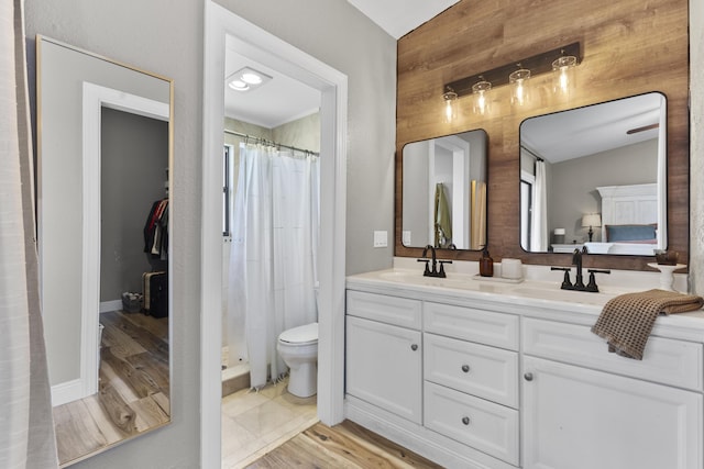 1693 Woodbridge Lakes Cir, West Palm Beach, FL 33406 - full bath featuring double vanity, a shower with curtain, toilet, wood finished floors, and baseboards