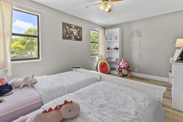 1693 Woodbridge Lakes Cir, West Palm Beach, FL 33406 - bedroom featuring light wood-style flooring, baseboards, and ceiling fan