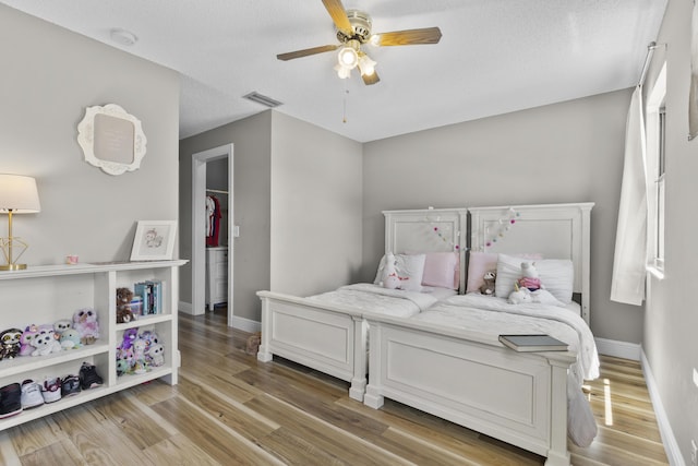 1693 Woodbridge Lakes Cir, West Palm Beach, FL 33406 - bedroom featuring light wood-type flooring, baseboards, and ceiling fan