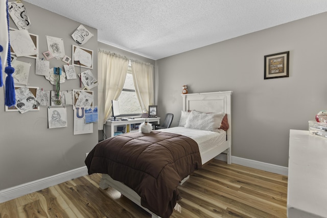 1693 Woodbridge Lakes Cir, West Palm Beach, FL 33406 - bedroom featuring wood finished floors, baseboards, and a textured ceiling
