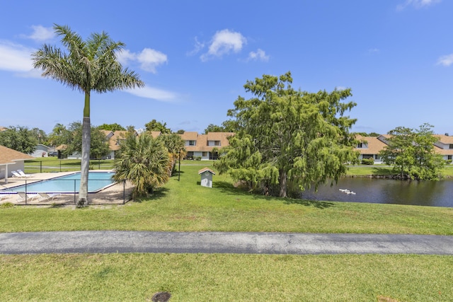 1693 Woodbridge Lakes Cir, West Palm Beach, FL 33406 - community pool featuring a water view, a residential view, and a lawn
