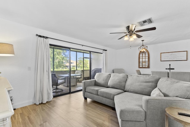 1693 Woodbridge Lakes Cir, West Palm Beach, FL 33406 - living area with a ceiling fan, light wood finished floors, and baseboards
