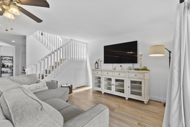 1693 Woodbridge Lakes Cir, West Palm Beach, FL 33406 - living area with ceiling fan, light wood-type flooring, baseboards, and stairs