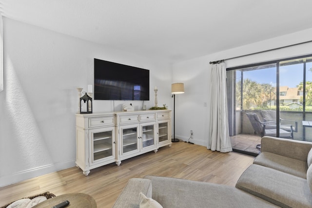 1693 Woodbridge Lakes Cir, West Palm Beach, FL 33406 - living room featuring light wood-type flooring and baseboards