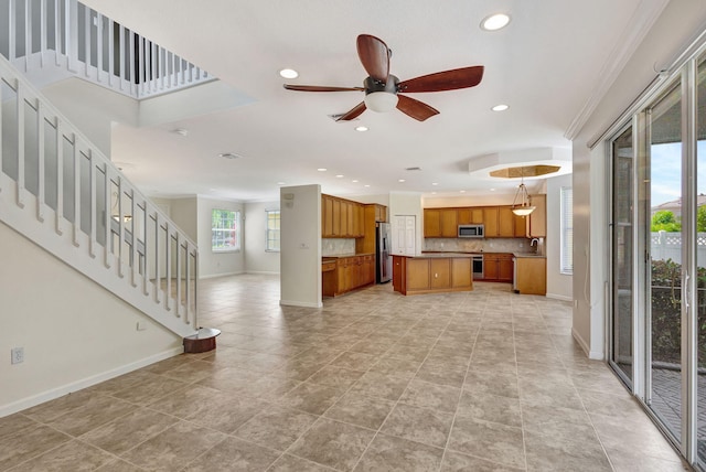 unfurnished living room with a ceiling fan, stairs, baseboards, recessed lighting, and a sink
