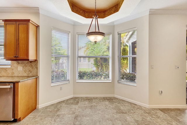 unfurnished dining area featuring baseboards, a raised ceiling, light tile patterned floors, and a healthy amount of sunlight
