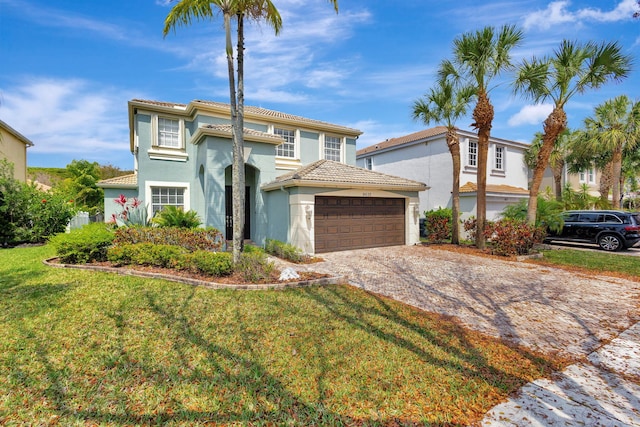 view of front of house with stucco siding, an attached garage, driveway, and a tiled roof