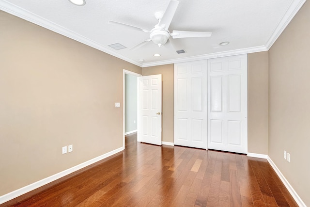 unfurnished bedroom featuring crown molding, recessed lighting, baseboards, wood finished floors, and visible vents
