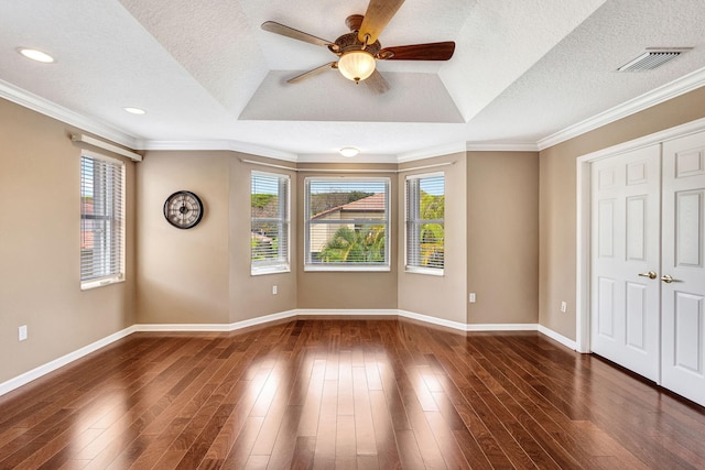 unfurnished bedroom featuring crown molding, baseboards, dark wood-style floors, and visible vents