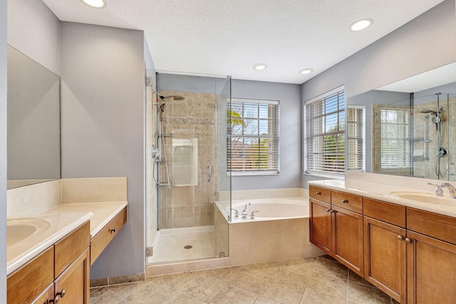 bathroom with a sink, a shower stall, a bath, and two vanities