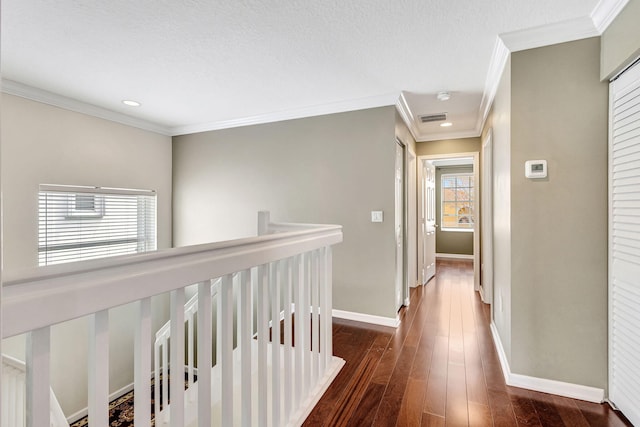corridor with crown molding, dark wood-style flooring, recessed lighting, baseboards, and visible vents