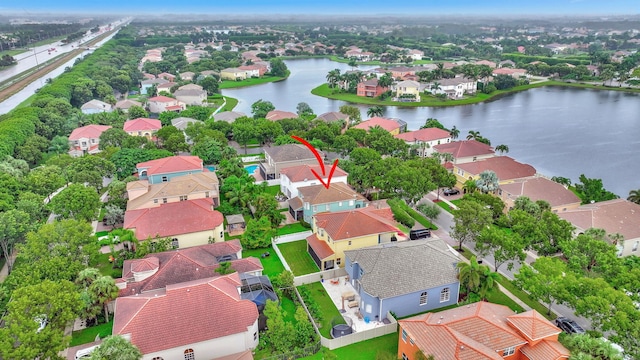 drone / aerial view featuring a residential view and a water view