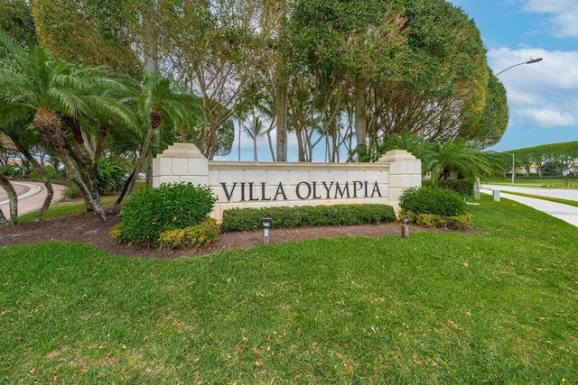 community / neighborhood sign with a yard