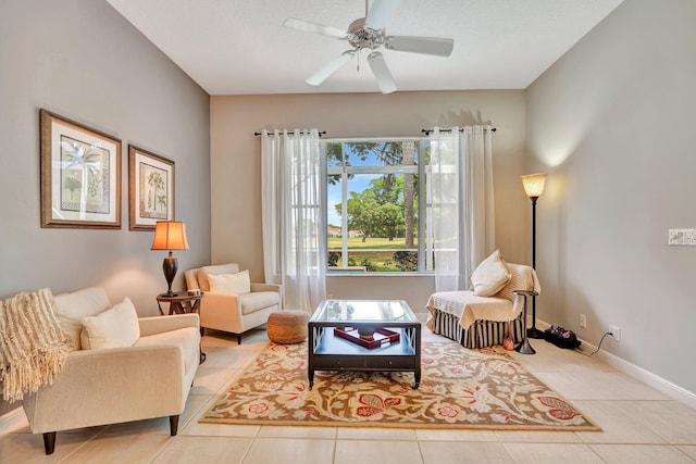 living area featuring baseboards, tile patterned flooring, and a ceiling fan