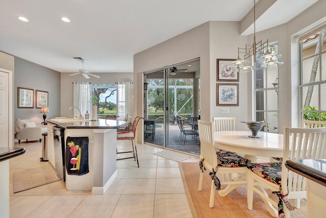 dining area featuring light tile patterned floors, a wealth of natural light, and ceiling fan
