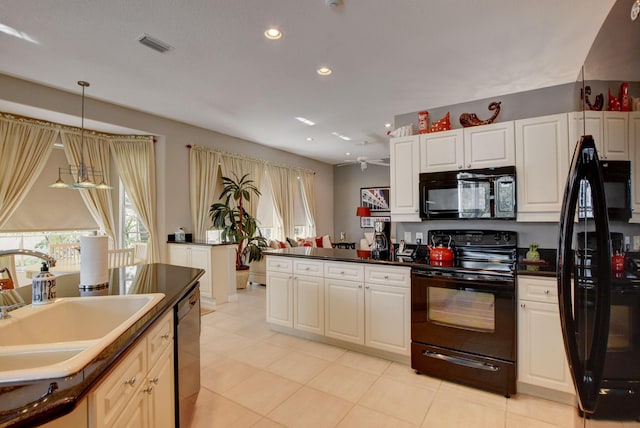 kitchen with a sink, black appliances, visible vents, recessed lighting, and dark countertops