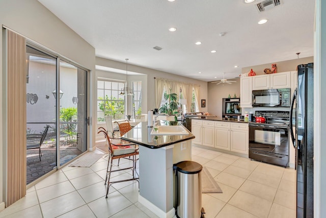 kitchen featuring dark countertops, visible vents, black appliances, and recessed lighting