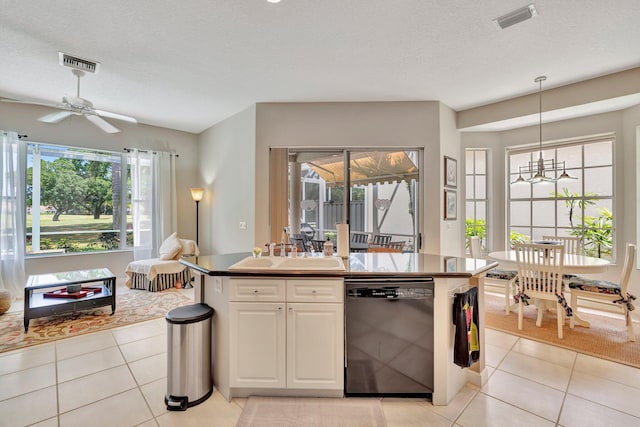 kitchen with black dishwasher, light tile patterned flooring, visible vents, a sink, and white cabinets