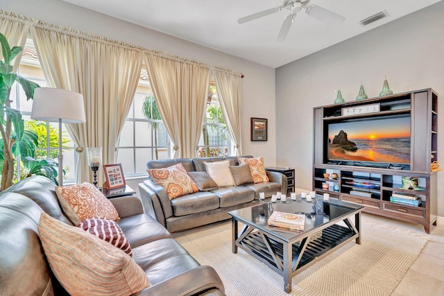 living room with a ceiling fan and visible vents