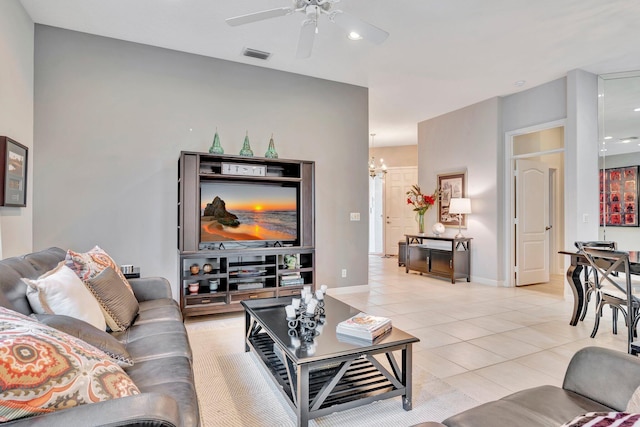 living area with light tile patterned floors, ceiling fan with notable chandelier, visible vents, baseboards, and recessed lighting