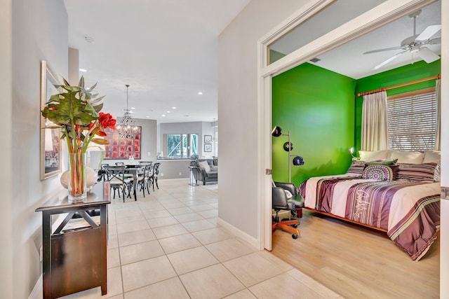 tiled bedroom with a chandelier, baseboards, and recessed lighting