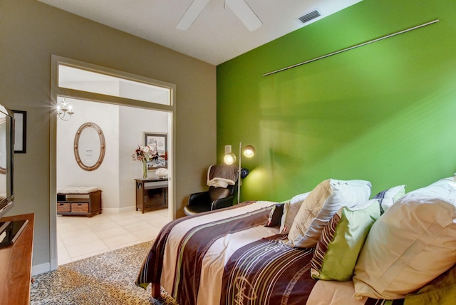 bedroom featuring a ceiling fan, baseboards, tile patterned floors, and visible vents