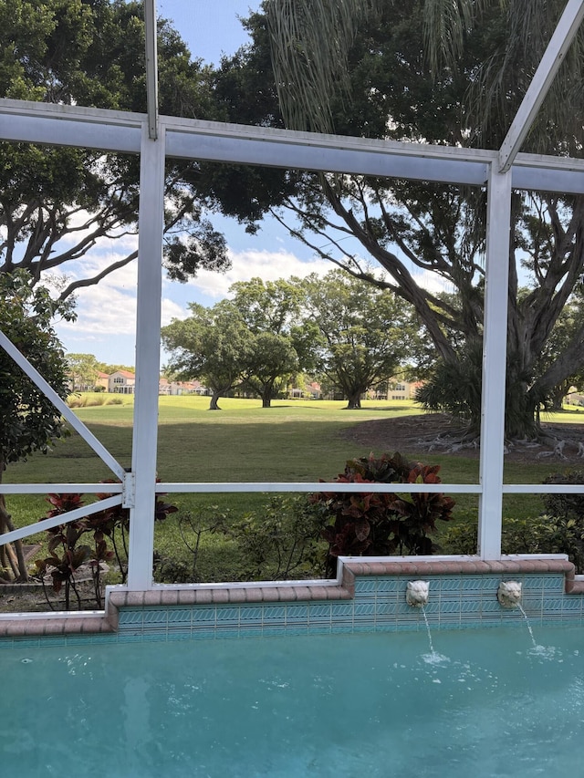 view of pool with a lawn