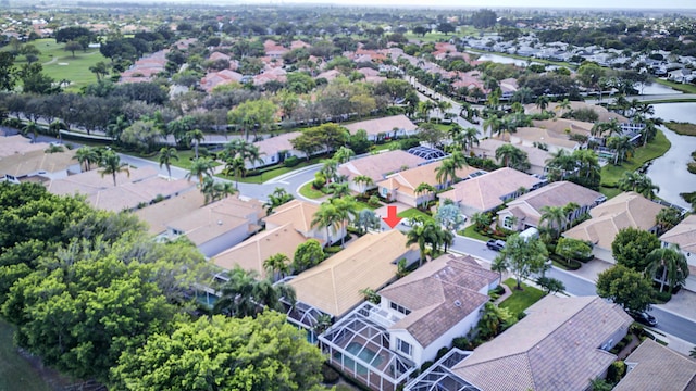 drone / aerial view with a water view and a residential view
