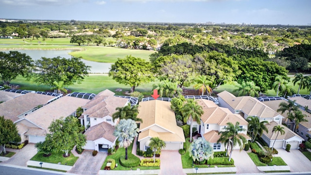 drone / aerial view with view of golf course, a water view, and a residential view