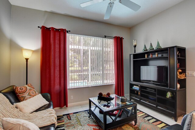 tiled living area featuring a wealth of natural light, baseboards, and ceiling fan