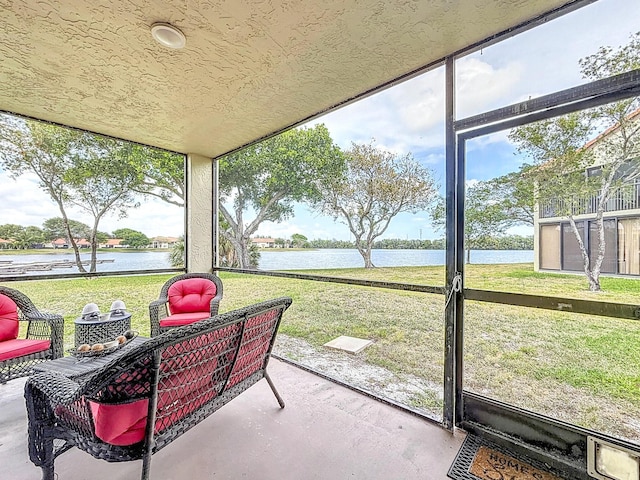 sunroom / solarium with a water view and plenty of natural light