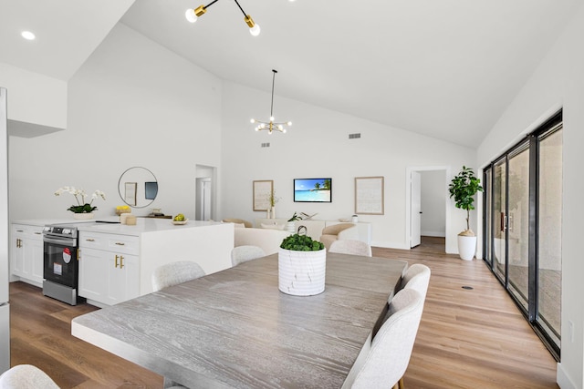 2795 Hawthorne Ln, West Palm Beach, FL 33409 - dining area with light wood-style floors, a chandelier, high vaulted ceiling, recessed lighting, and baseboards