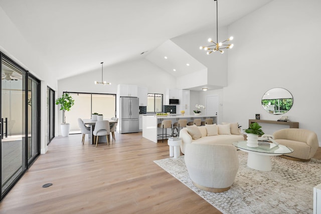2795 Hawthorne Ln, West Palm Beach, FL 33409 - living room featuring a chandelier, light wood-style flooring, high vaulted ceiling, and recessed lighting