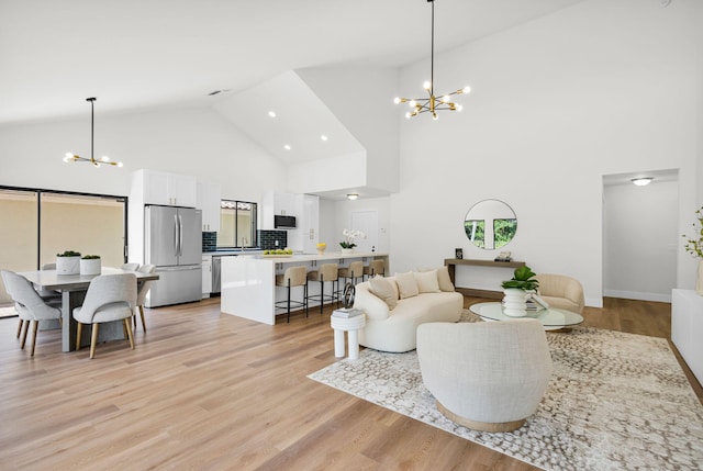 2795 Hawthorne Ln, West Palm Beach, FL 33409 - living area featuring a chandelier, high vaulted ceiling, light wood-style flooring, plenty of natural light, and recessed lighting