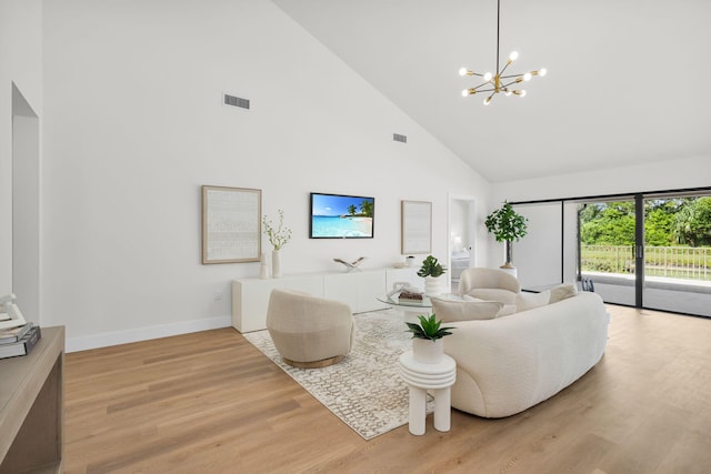 2795 Hawthorne Ln, West Palm Beach, FL 33409 - living area with high vaulted ceiling, light wood-style flooring, a chandelier, and baseboards