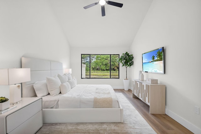 2795 Hawthorne Ln, West Palm Beach, FL 33409 - bedroom with high vaulted ceiling, baseboards, wood finished floors, and ceiling fan