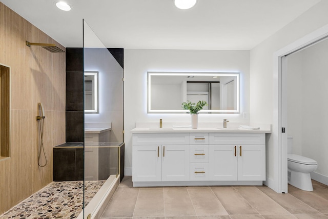 2795 Hawthorne Ln, West Palm Beach, FL 33409 - full bathroom with walk in shower, toilet, double vanity, tile patterned floors, and baseboards