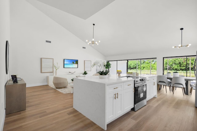 2795 Hawthorne Ln, West Palm Beach, FL 33409 - kitchen with a chandelier, electric range, high vaulted ceiling, white cabinets, and open floor plan