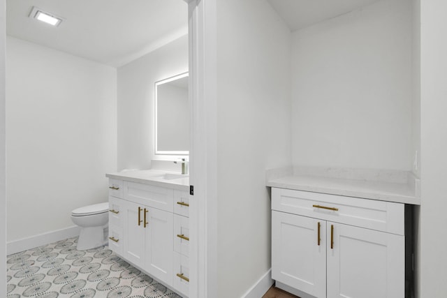 2795 Hawthorne Ln, West Palm Beach, FL 33409 - bathroom featuring toilet, baseboards, and vanity