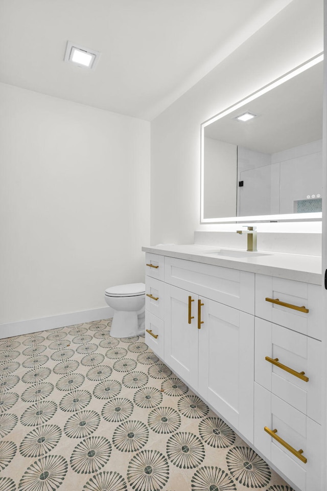 2795 Hawthorne Ln, West Palm Beach, FL 33409 - bathroom with toilet, vanity, and baseboards