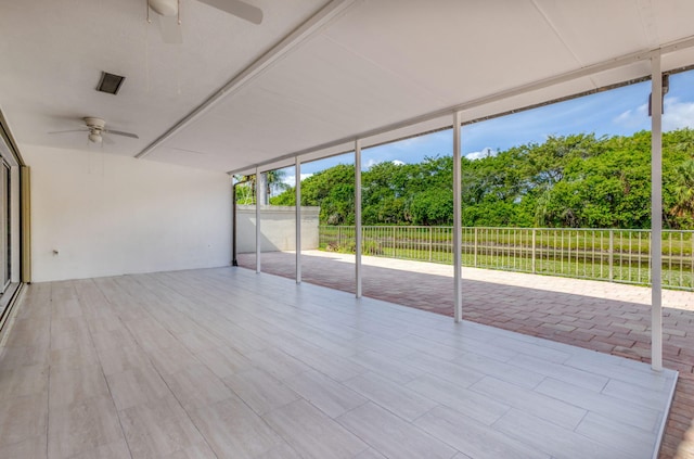 2795 Hawthorne Ln, West Palm Beach, FL 33409 - unfurnished sunroom featuring ceiling fan and view of scattered trees