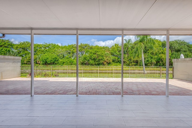 2795 Hawthorne Ln, West Palm Beach, FL 33409 - unfurnished sunroom featuring view of scattered trees