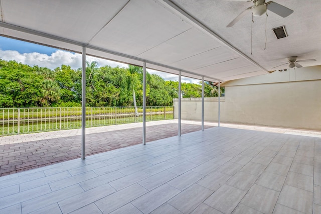 2795 Hawthorne Ln, West Palm Beach, FL 33409 - unfurnished sunroom with view of wooded area