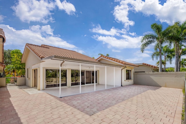 2795 Hawthorne Ln, West Palm Beach, FL 33409 - rear view of house featuring a tiled roof, a ceiling fan, a patio area, and stucco siding