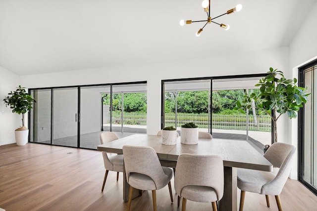 2795 Hawthorne Ln, West Palm Beach, FL 33409 - dining room with a chandelier, healthy amount of natural light, vaulted ceiling, and wood finished floors