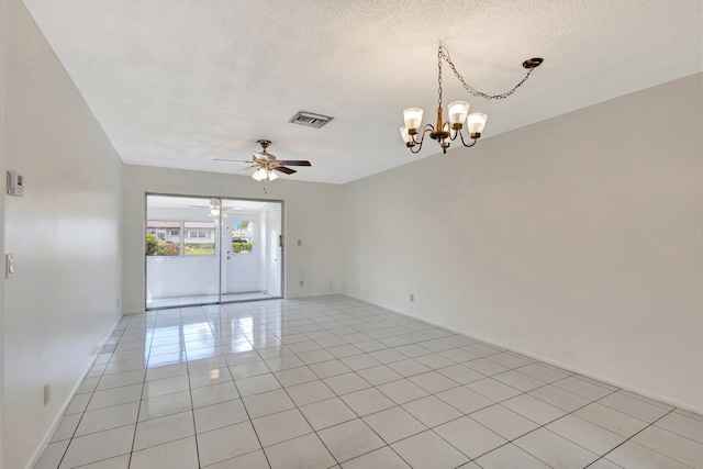 spare room featuring light tile patterned floors, ceiling fan with notable chandelier, a textured ceiling, and visible vents