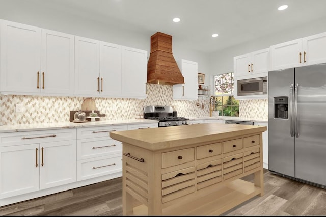 7 Via Tivoli, Palm Beach Gardens, FL 33418 - kitchen featuring appliances with stainless steel finishes, tasteful backsplash, custom exhaust hood, dark wood-style floors, and butcher block countertops